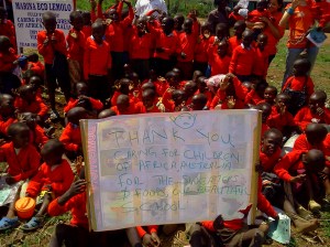 Lemolo students show off their new sweaters, thanks to Caring for the Children of Africa.