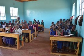 Students in their new classrooms with new seats.